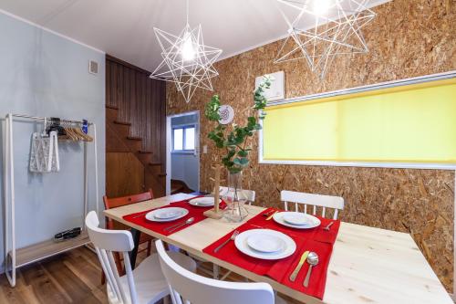 Un comedor con una mesa y sillas rojas. en Cozy House, en Tokio