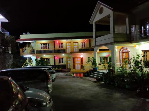 a house with cars parked in front of it at night at Misba Homestay Kodai in Kodaikānāl
