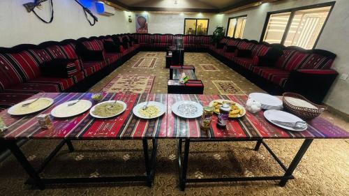 a table with plates on it in a room at Wadi Rum Oryx Hostel & Tours in Wadi Rum