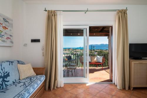 a living room with a sliding glass door leading to a patio at Sea Shell - Klodge in Olbia