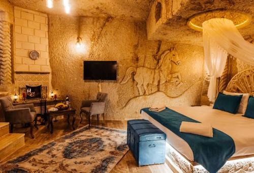 a bedroom with a bed in a room with a stone wall at Bayar Cave Suites in Urgup