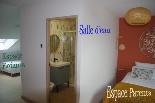 a bedroom with a bathroom with a sink and a vanity at Au Temps Retrouvé in Nouans-les-Fontaines
