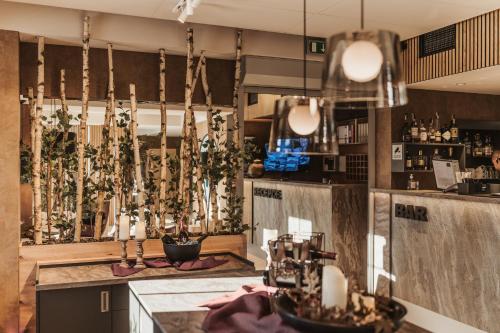 a bar with candles and plants on a counter at Hotel Resort Relax in Dolní Vltavice