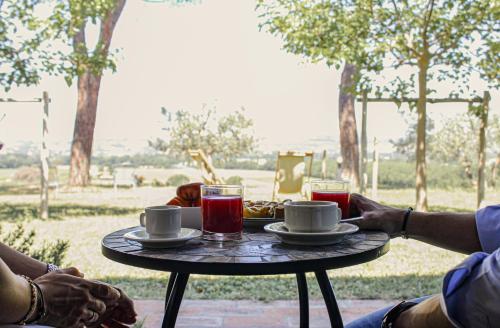 a table with cups of tea and drinks on it at Poggio alle Vigne in Torgiano