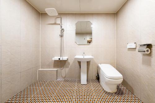 a bathroom with a toilet and a sink at Incheon BoscoHotel in Incheon