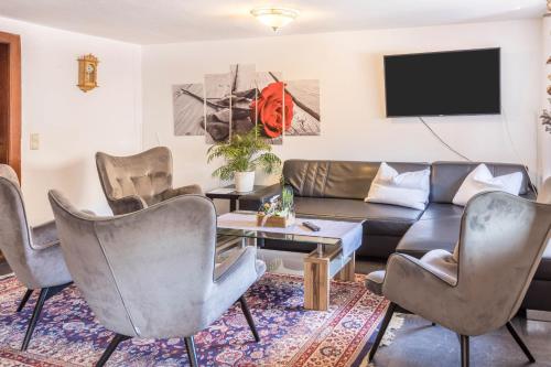 a living room with a couch and chairs at Haus Steinatal in Ühlingen-Birkendorf