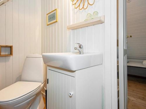 a bathroom with a sink and a toilet at Modern Holiday Home in Rømø with Sauna in Toftum