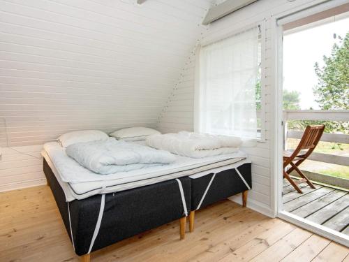 Cama en habitación con ventana en Modern Holiday Home in Rømø with Sauna en Toftum