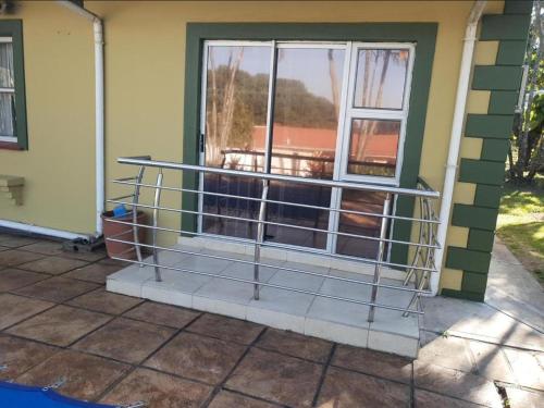 a screened in porch with a window at Edwaleni Guest Lodge in Pinetown