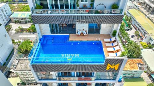 an aerial view of a building with a swimming pool at Maris Hotel Nha Trang in Nha Trang