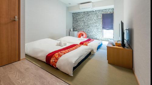 Una cama o camas en una habitación de 匯金北池袋ビル