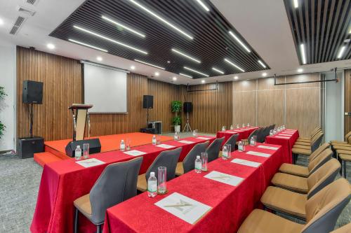 a large conference room with red tables and chairs at Maris Hotel Nha Trang in Nha Trang