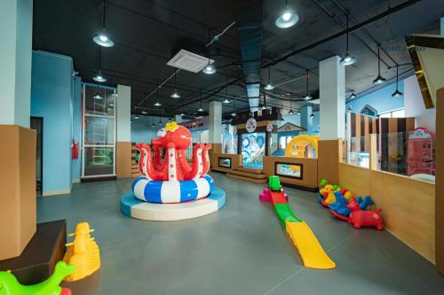 a childrens play room with a playground and a slide at D'Lioro Hotel & Resort in Ha Long