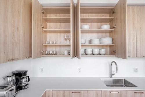 a kitchen with wooden cabinets and a sink at Clinton Hill 2br w wd gym pool nr BAM NYC-971 in Brooklyn