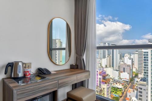 a hotel room with a desk and a window at Maris Hotel Nha Trang in Nha Trang