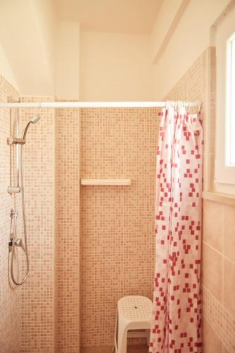 a bathroom with a shower with a shower curtain at Case Vacanza Torre Canne in Torre Canne