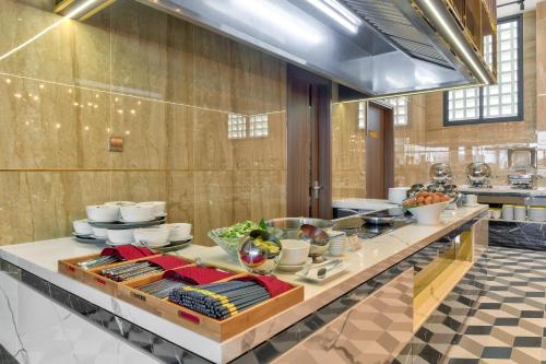 a kitchen with a counter with food on it at Maris Hotel Nha Trang in Nha Trang