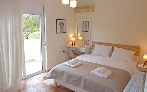a bedroom with a bed with two towels on it at Panoramic Sea View Villa 4 Min to Beach in Tigaki