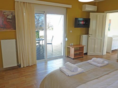 a bedroom with a bed with two towels on it at Panoramic Sea View Villa 4 Min to Beach in Tigaki