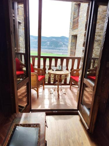 a view of a balcony with a table and chairs at Apartamentos El Rincón de Usana Zona Zero in Aínsa