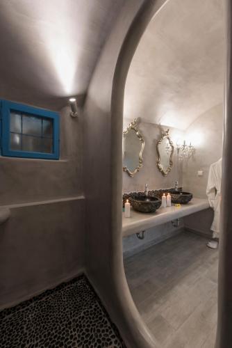 a bathroom with two sinks and a mirror at Simantiri Private Villa in Megalochori