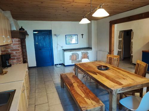a dining room with a wooden table and a fireplace at Apartment Le 1739 in La Coste