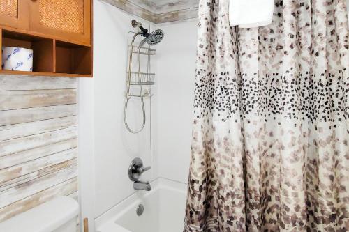 a bathroom with a shower curtain and a tub at A Bear's Lodge #613 in Sevierville