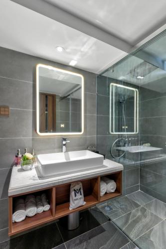 a bathroom with a sink and a mirror at Maris Hotel Nha Trang in Nha Trang