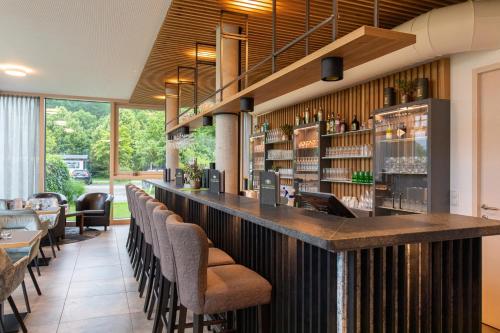 a bar in a restaurant with a bunch of chairs at Hotel Hausschachen in Weitra