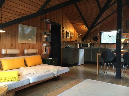 a living room with a couch and a kitchen at Enjoy The Nature And Quiteness Of Anholt in Anholt