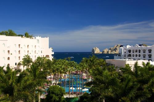 a view of a resort with palm trees and the ocean at Pueblo Bonito Rose Resort & Spa - All Inclusive in Cabo San Lucas