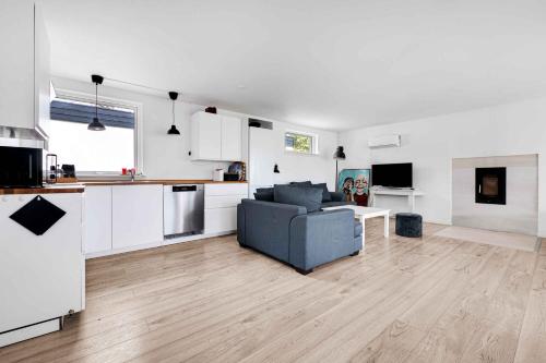 a living room with a couch and a kitchen at Amazing Holiday Home With View At The Water in Vig