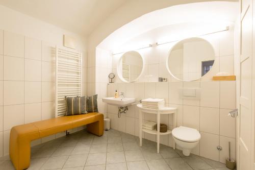 a bathroom with a toilet and a sink and mirror at Sound of Music World Appartement in Salzburg