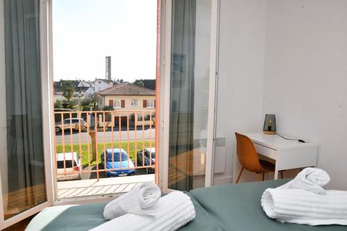 um quarto com uma cama e uma janela com vista em Vue Pyrénéenne Élégante avec 2 chambres em Tarbes