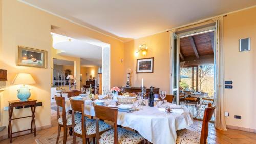 a dining room with a table and chairs at Uvaspina 8, Emma Villas in Antignano