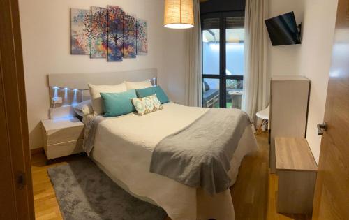 a bedroom with a large bed and a window at VIANA in Monforte de Lemos