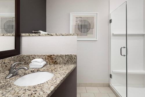 a bathroom with a sink and a mirror at Courtyard By Marriott Little Rock North in North Little Rock