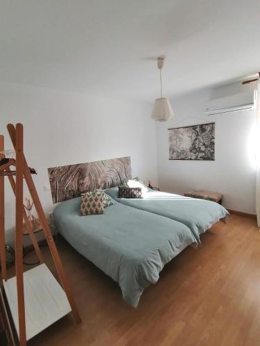 a bedroom with two large beds and a ladder at El Vergel del Piedra in Munébrega