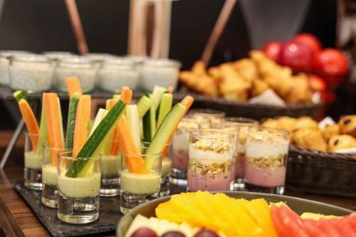 a table topped with different types of food and drinks at Novotel Poznań Malta in Poznań