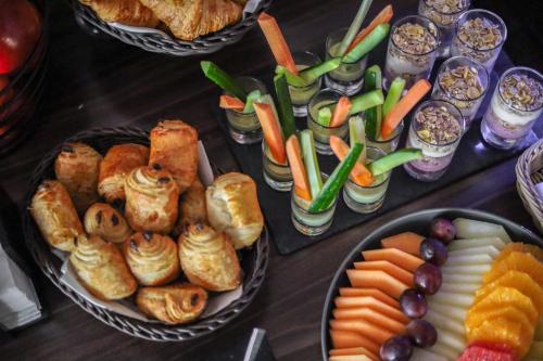 a table topped with two trays of different types of food at Novotel Poznań Malta in Poznań