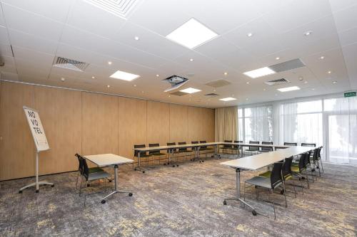 a large room with tables and chairs in it at Novotel Poznań Malta in Poznań