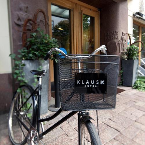 a bike with a basket parked in front of a building at Hotel Klaus K in Helsinki