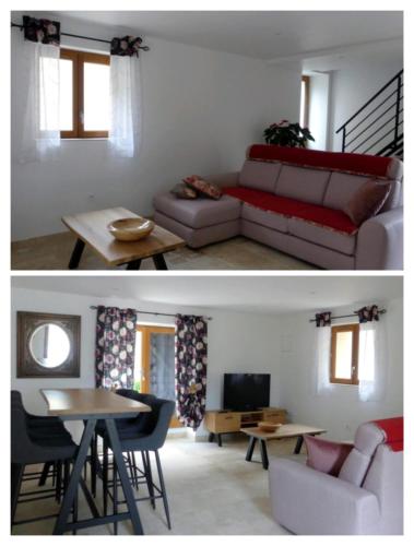 a living room with a couch and a table at L'étoile de Zakiel in Cambayrac