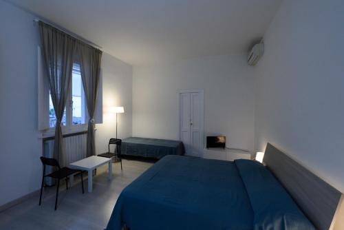 a bedroom with a blue bed and a window at JacAl in Foligno