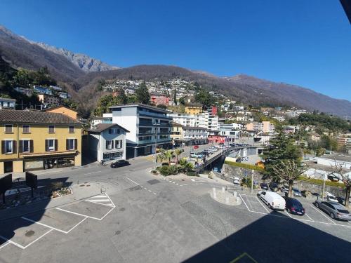an aerial view of a city with cars parked in a parking lot at Appartamento Fidanza 4 in Brissago Center in Brissago