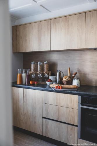 a kitchen with a counter with fruits and vegetables on it at Münsterhus by A-Appartments in Schruns-Tschagguns