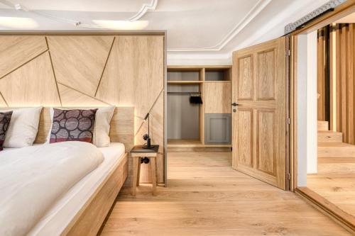 a bedroom with a bed and a wooden floor at Münsterhus by A-Appartments in Schruns-Tschagguns