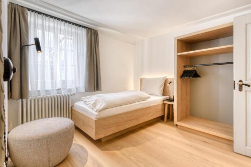 a small bedroom with a bed and a window at Münsterhus by A-Appartments in Schruns-Tschagguns
