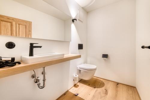 a bathroom with a sink and a toilet at Münsterhus by A-Appartments in Schruns-Tschagguns