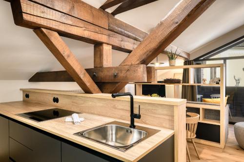 a kitchen with a sink in a wooden counter top at Münsterhus by A-Appartments in Schruns
